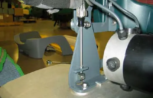 Turning the adjustment screw on the right-hand side of the scrub head with a screwdriver