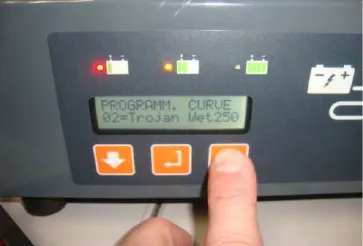 Charger panel display reading PROGRAMM. CURVE 02=Trojan Wet250 with a finger on the up arrow button