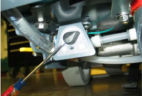 Loosening the set screws on the water solenoid knob with a screwdriver