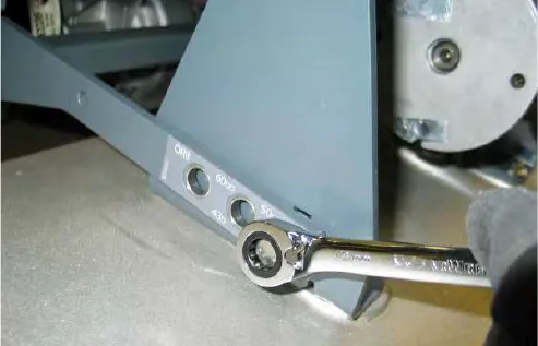 Loosening the right-hand side linkage bolt with a ratchet wrench