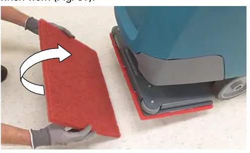 Turning the red orbital work pad over next to the machine