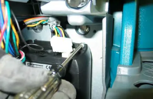 Removing a battery charger mounting torx screw with a screwdriver