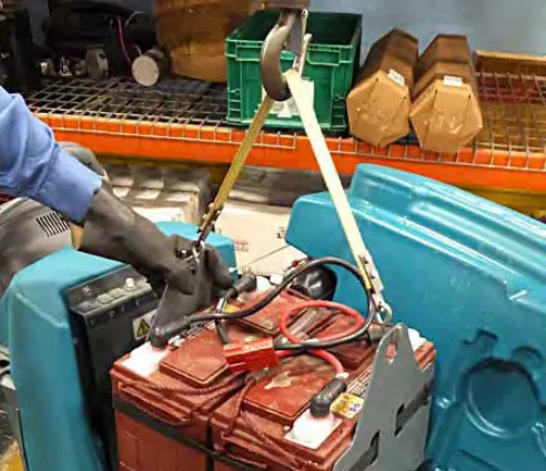 Lifting a battery out of the battery compartment with a strap and hoist