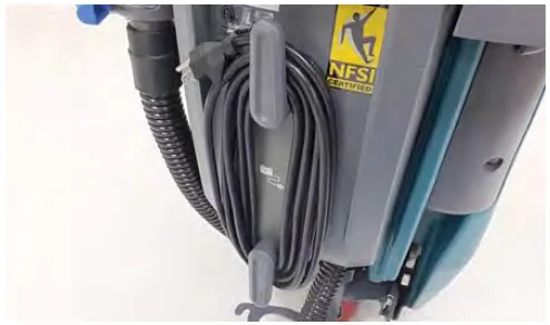 Charger power cord wrapped around the cord hooks on the machine