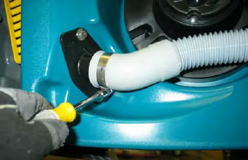 Loosening the hose clamp on the rear squeegee hose at the recovery tank