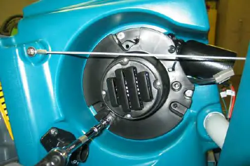 Removing a vacuum fan mounting bolt with a ratchet