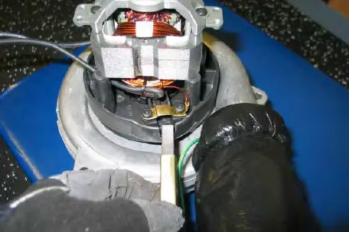 Lifting a carbon brush out of the vacuum motor