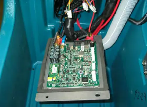 Heat sink and machine control module lowered, showing the circuit board and wiring