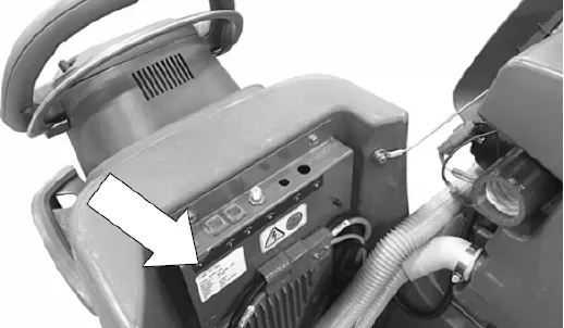 Photo of the rear control area of the machine with an arrow pointing to the serial number plate