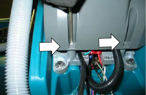 Arrows pointing at the two torx screws under the control console