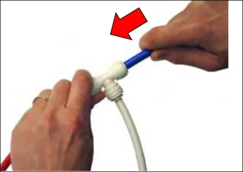Pushing the tube fully into the tube stop, with a red arrow
