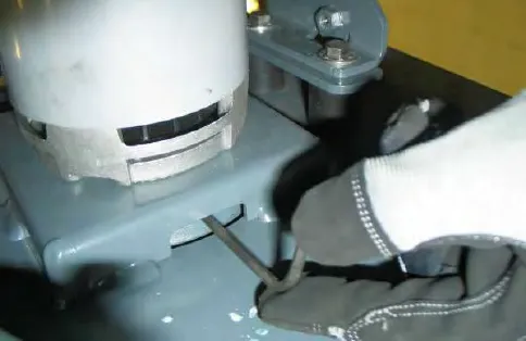 Loosening the set screw on the concentric motor weight with a hex key