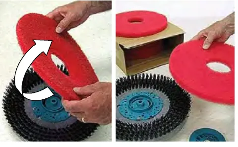 Turning a red disk pad over on the scrub head and a new pad beside it