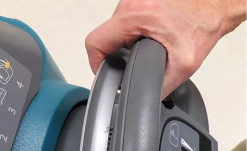 Hand squeezing the handle on the operator console