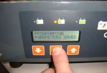 Charger display reading PROGRAMMING PARAMETERS SAVED with a finger on the middle button
