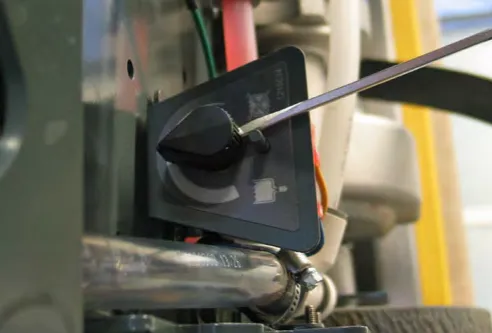 Loosening the set screw on the water solenoid knob with a screwdriver