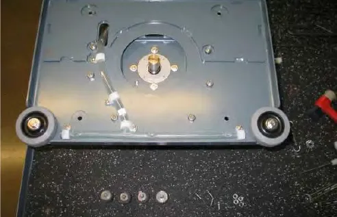 Lower plate removed, showing the motor shaft and the four lower isolators set aside