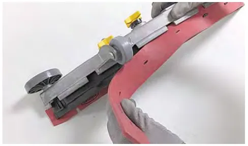 Pulling the worn red squeegee blade out of the blade retainer