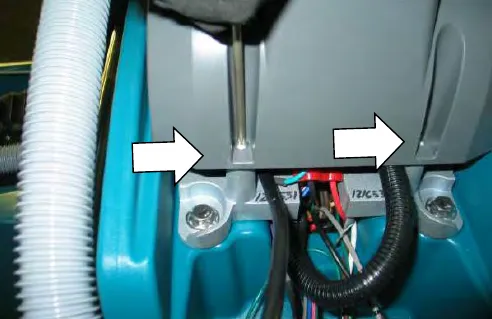 Arrows pointing at the two torx screws under the control console