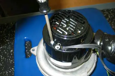 Removing a torx screw from the vacuum fan cover