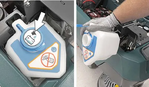 Automatic battery watering tank with the blue cap, and the tank lifted out and emptied