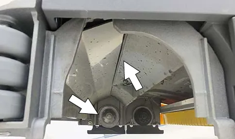 Underside of the cylindrical scrub head with the idler plates and drive hubs marked