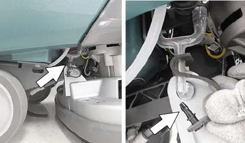 Drain hose cap below the battery watering tank marked by arrows