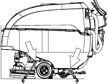 Side view of the machine in a trailer with tie-down straps at the front and rear brackets and a block behind each wheel