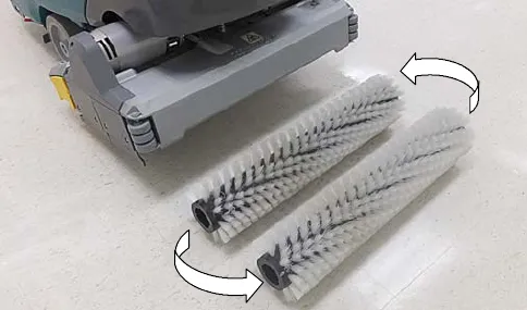 Two cylindrical brushes being swapped front to rear