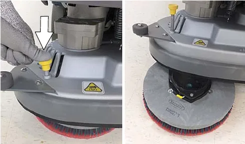 Pressing the yellow pad release plunger so the pad drops to the floor