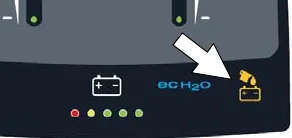 Control panel with an arrow pointing at the automatic battery watering indicator