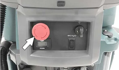 Arrow pointing at the red emergency shut-off button on the control housing