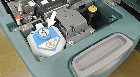 Automatic battery watering tank in the battery compartment with the blue cap