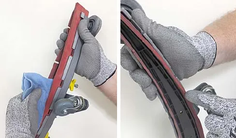 Wiping the squeegee blade with a cloth and inspecting it