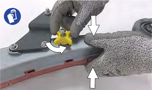 Loosening a yellow knob on the squeegee assembly while squeezing the blade retainer and frame together