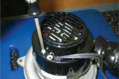 Vacuum fan motor with the cover hardware being removed