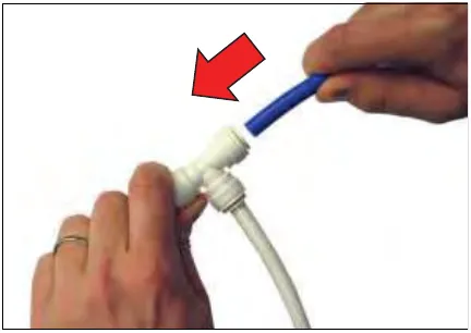 Hand pushing a blue tube into a push-to-connect fitting, with a red arrow