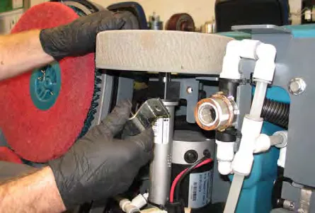 Transaxle mounting bracket and wheel seen from beneath the machine