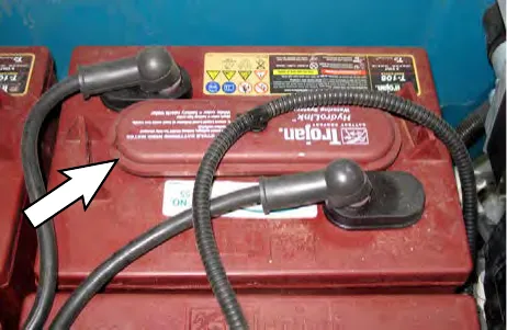 Arrow pointing to a battery vent cap