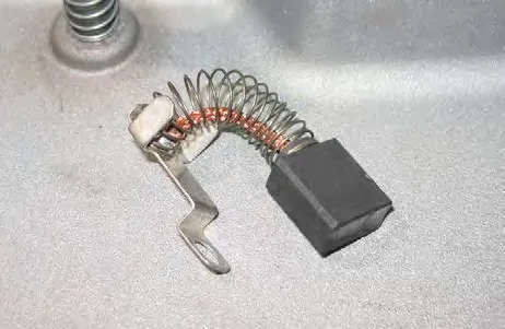 Removed carbon brush assembly with spring