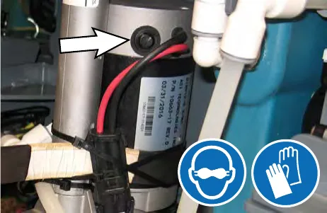 Arrow pointing to the drive motor access cover; safety glasses and gloves symbols shown