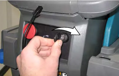 Hand turning the key switch clockwise to the ON position