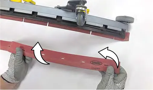 Rotating the rear blade to a new wiping edge and aligning its slots with the retainer tabs