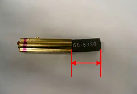 Carbon brush with its length marked by a red double-headed arrow