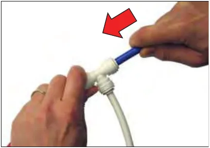 Tube pushed fully into the fitting, with a red arrow