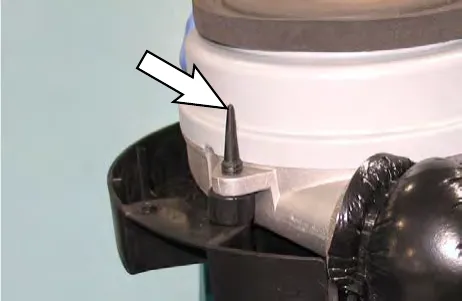 Arrow pointing to a vibration isolator inserted in the vacuum fan