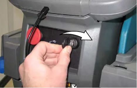 Hand turning the key switch clockwise to the ON position