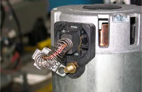 Carbon brush assembly inside the disk brush motor