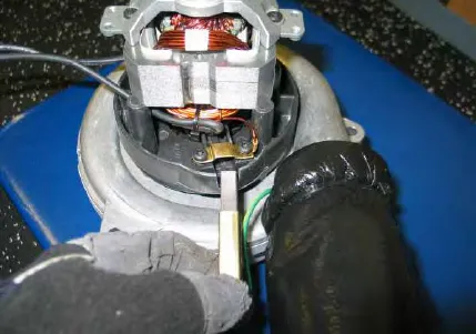 Vacuum fan motor with a carbon brush being lifted out