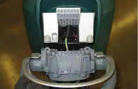 Operator console lifted away from the machine with its wiring exposed